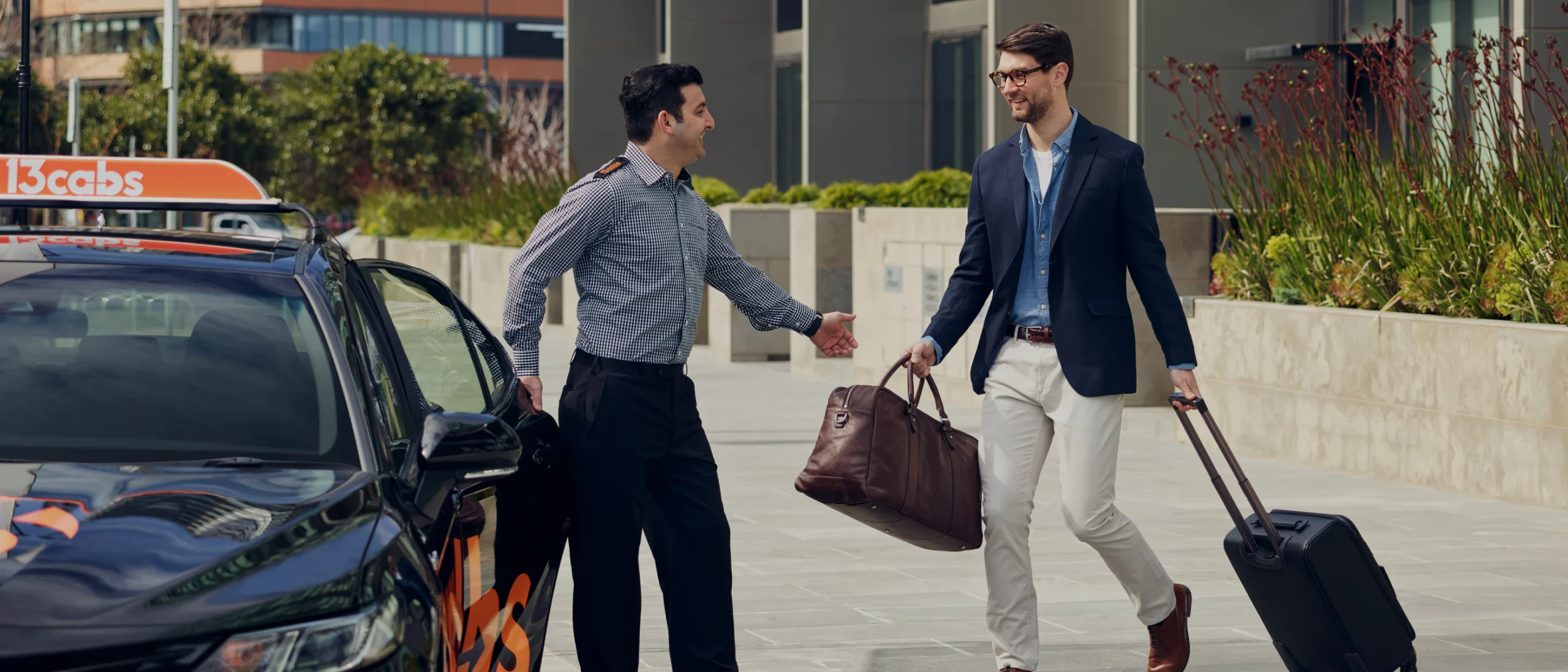 13cabs driver helping man with baggage